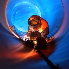 An man welding in a tunnel